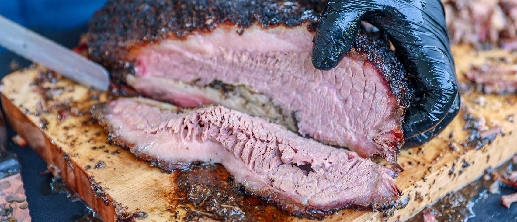 Texas brisket being sliced during service prep